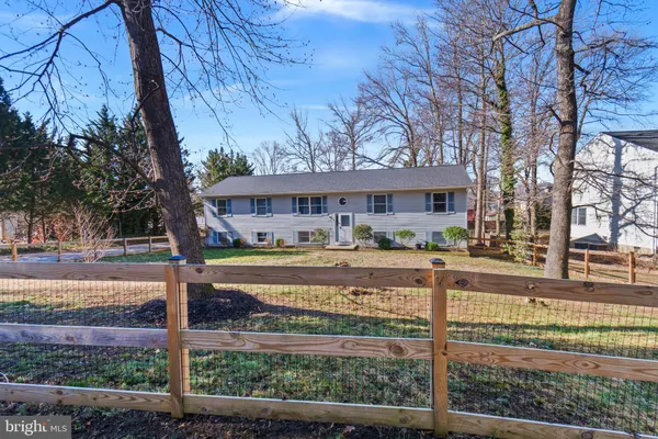 a view of a house with a yard and tree s