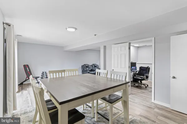 a view of a workspace with furniture and wooden floor