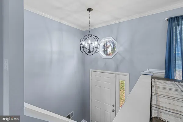 a large kitchen with stainless steel appliances kitchen island granite countertop a stove a sink dishwasher and a refrigerator with wooden floor