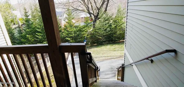 a view of balcony with wooden floor and fence