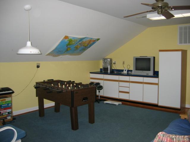 1306 Rand Drive Raleigh, NC 27608 - Photo 11 of 12 a room with furniture and a flat screen tv