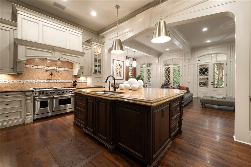 4136 North Stratford Road Northeast Atlanta, GA 30342 - Photo 19 of 78 a kitchen with stainless steel appliances granite countertop a stove and a sink