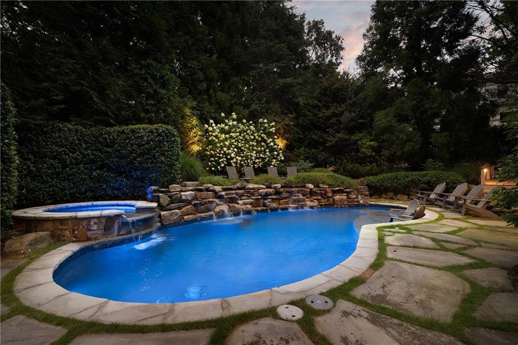4136 North Stratford Road Northeast Atlanta, GA 30342 - Photo 3 of 78 a view of a swimming pool with a yard