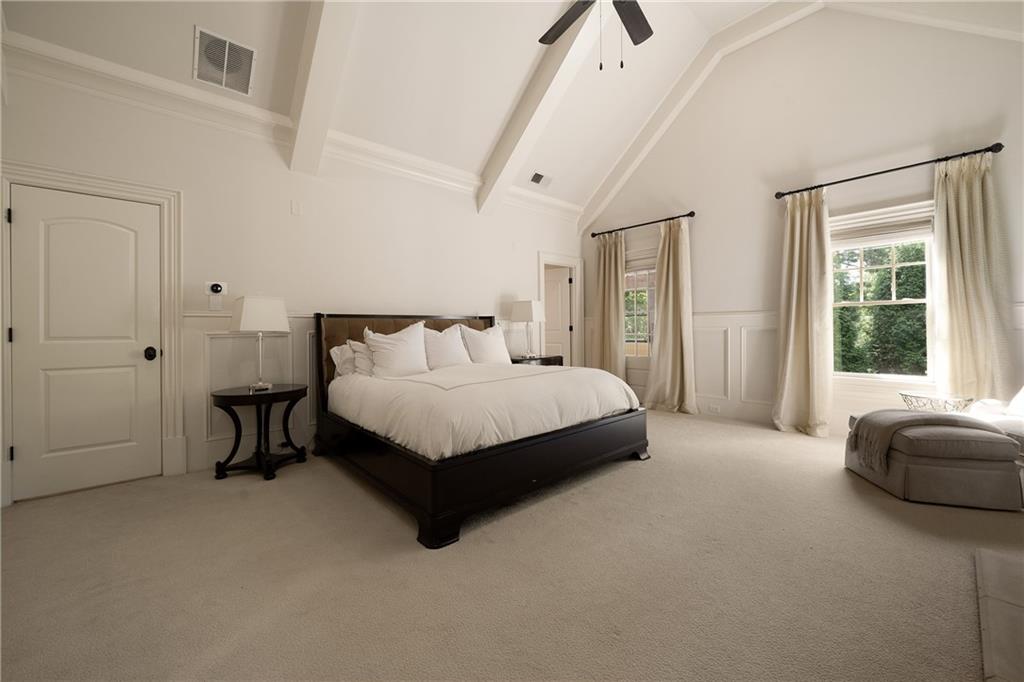 4136 North Stratford Road Northeast Atlanta, GA 30342 - Photo 33 of 78 a bedroom with a bed lamp and a window