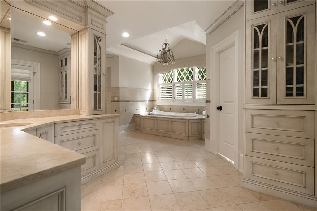 4136 North Stratford Road Northeast Atlanta, GA 30342 - Photo 35 of 78 a large white bathroom with a sink a large mirror and a bathtub
