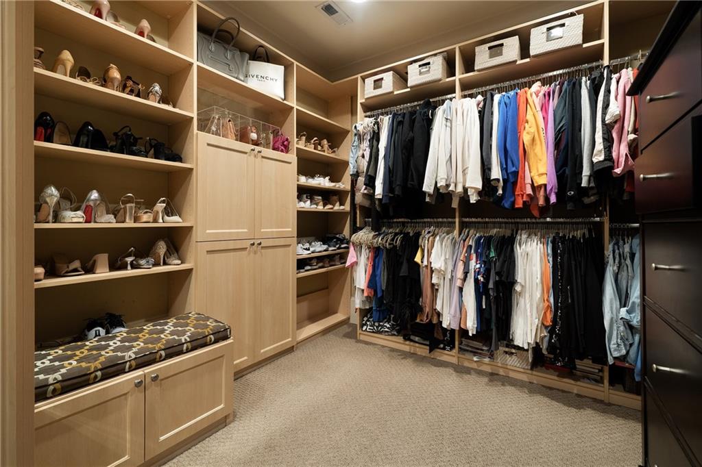 4136 North Stratford Road Northeast Atlanta, GA 30342 - Photo 40 of 78 a view of walk in closet with clothes and shoes