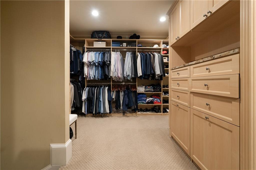 4136 North Stratford Road Northeast Atlanta, GA 30342 - Photo 41 of 78 a view of walk in closet with clothes and shoes