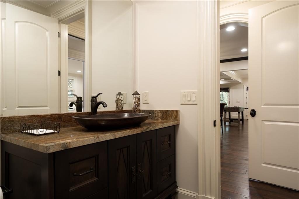 4136 North Stratford Road Northeast Atlanta, GA 30342 - Photo 59 of 78 a bathroom with a granite countertop sink and a mirror