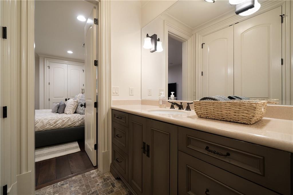 4136 North Stratford Road Northeast Atlanta, GA 30342 - Photo 61 of 78 a en suite bathroom with a granite countertop sink and a mirror