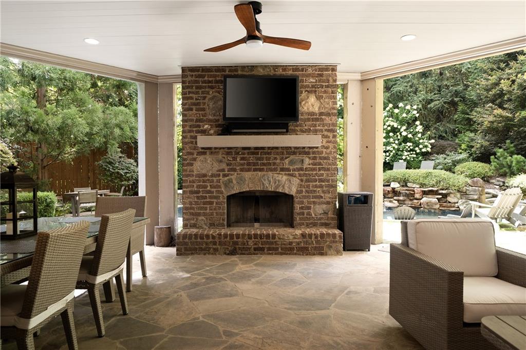 4136 North Stratford Road Northeast Atlanta, GA 30342 - Photo 63 of 78 a living room with furniture a flat screen tv and a fireplace