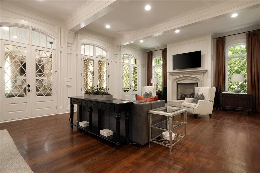 4136 North Stratford Road Northeast Atlanta, GA 30342 - Photo 9 of 78 a living room with furniture a fireplace and a flat screen tv