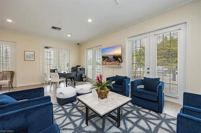 a living room with furniture a large window and a dining table