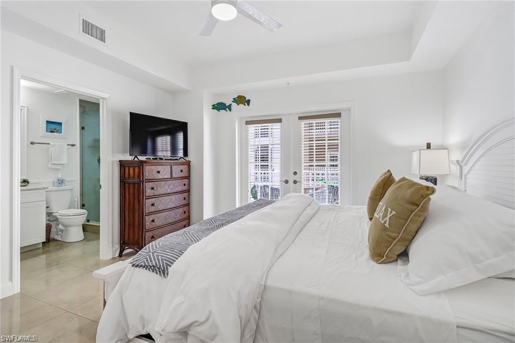 410 Bayfront Place, Unit 2208 Naples, FL 34102 - Photo 7 of 26 a bedroom with a bed and a flat screen tv