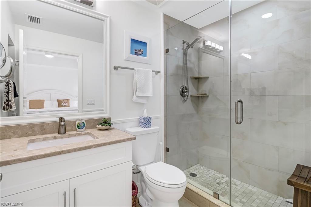 410 Bayfront Place, Unit 2208 Naples, FL 34102 - Photo 8 of 26 a bathroom with a shower sink mirror and toilet