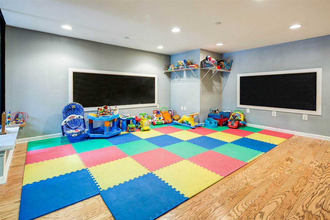 700 Grove Street, Unit 4V Jersey City, NJ 07310 - Photo 20 of 25 a room with lots of play ground and a flat screen tv
