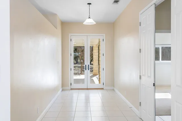 a large kitchen with a refrigerator a stove a sink dishwasher and white cabinets