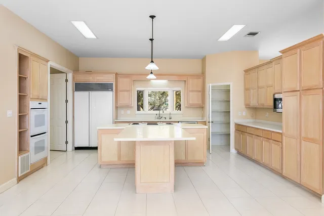 a kitchen with stainless steel appliances granite countertop a sink and cabinets