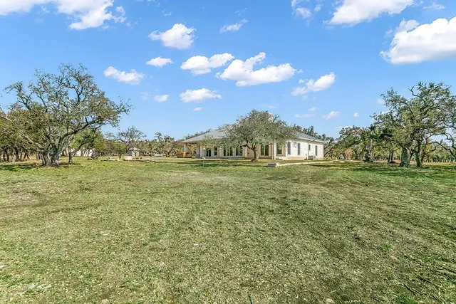 a view of outdoor space with garden and trees