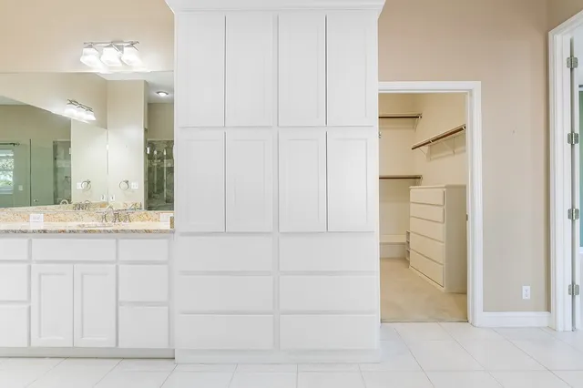a bathroom with a double vanity sink and a mirror