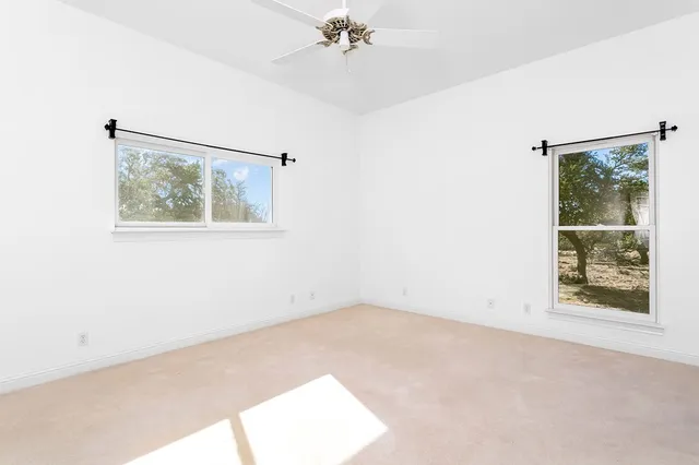 a view of dirt yard with a large tree