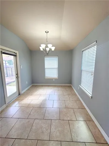 a view of a livingroom with a chandelier furniture and windows