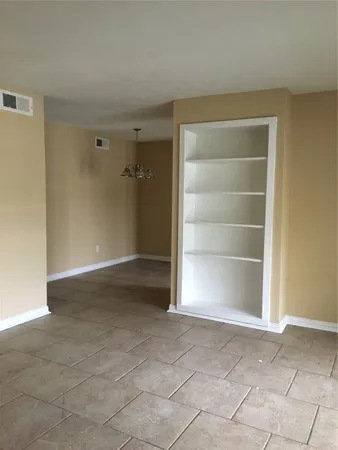 an empty room with a empty space and a window