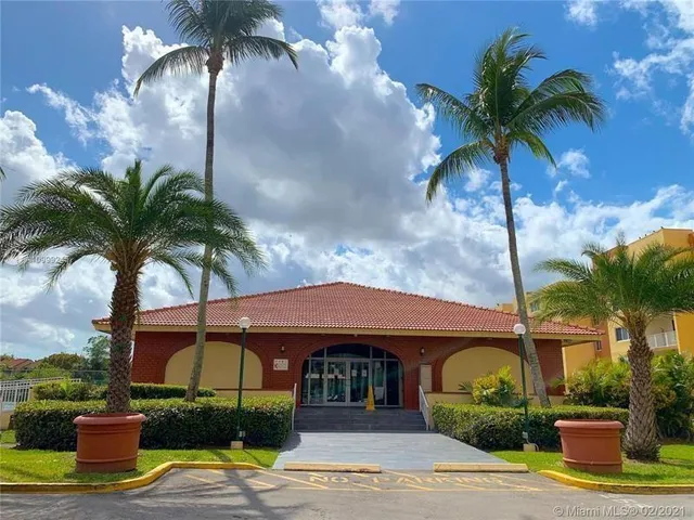 a front view of a house with garden and entryway
