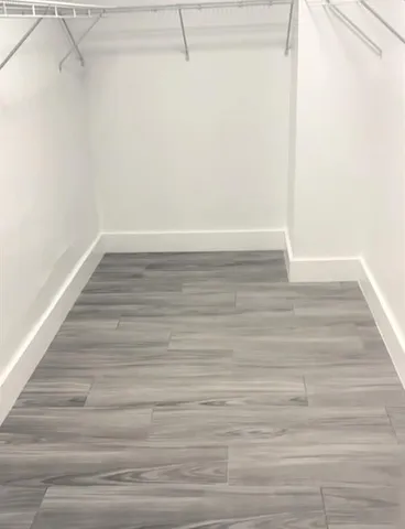 a view of a small space with wooden floor