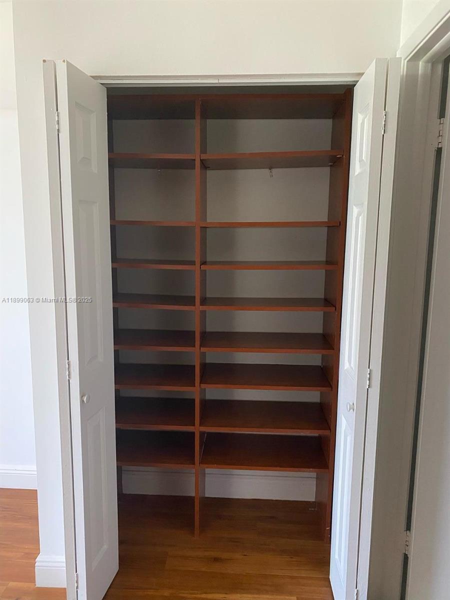 3300 Northeast 191st Street, Unit 416 Aventura, FL 33180 - Photo 13 of 26 a view of walk in closet with empty racks