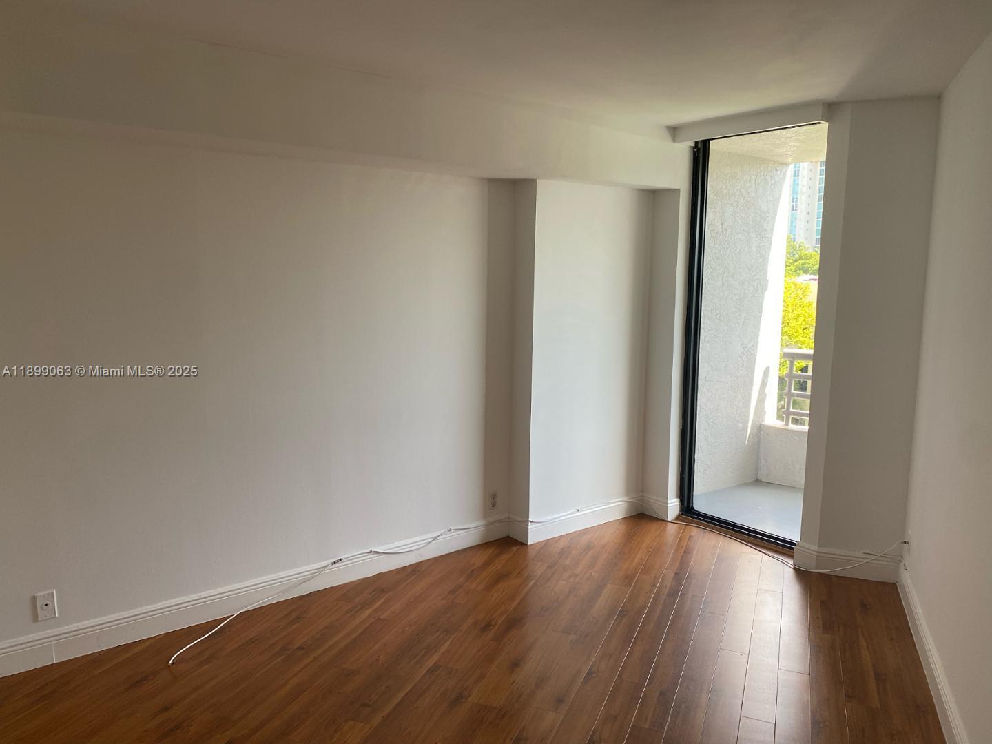 3300 Northeast 191st Street, Unit 416 Aventura, FL 33180 - Photo 14 of 26 an empty room with wooden floor and closet
