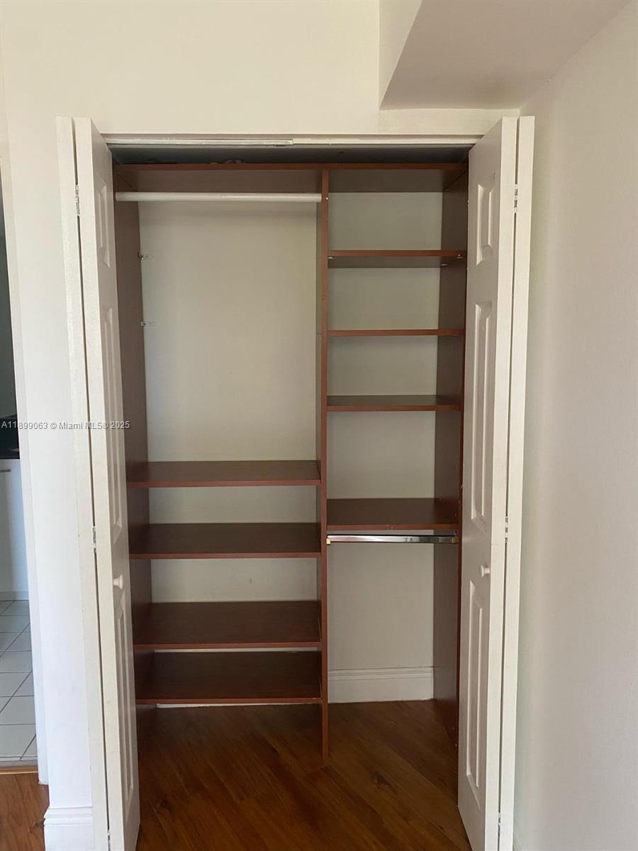 3300 Northeast 191st Street, Unit 416 Aventura, FL 33180 - Photo 16 of 26 a view of walk in closet with empty racks
