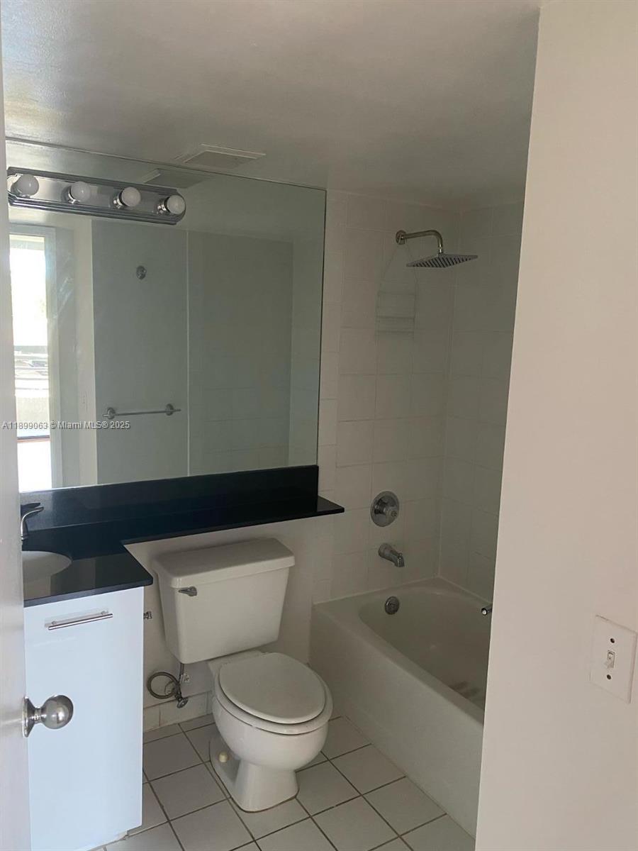 3300 Northeast 191st Street, Unit 416 Aventura, FL 33180 - Photo 17 of 26 a bathroom with a toilet a sink and bathtub