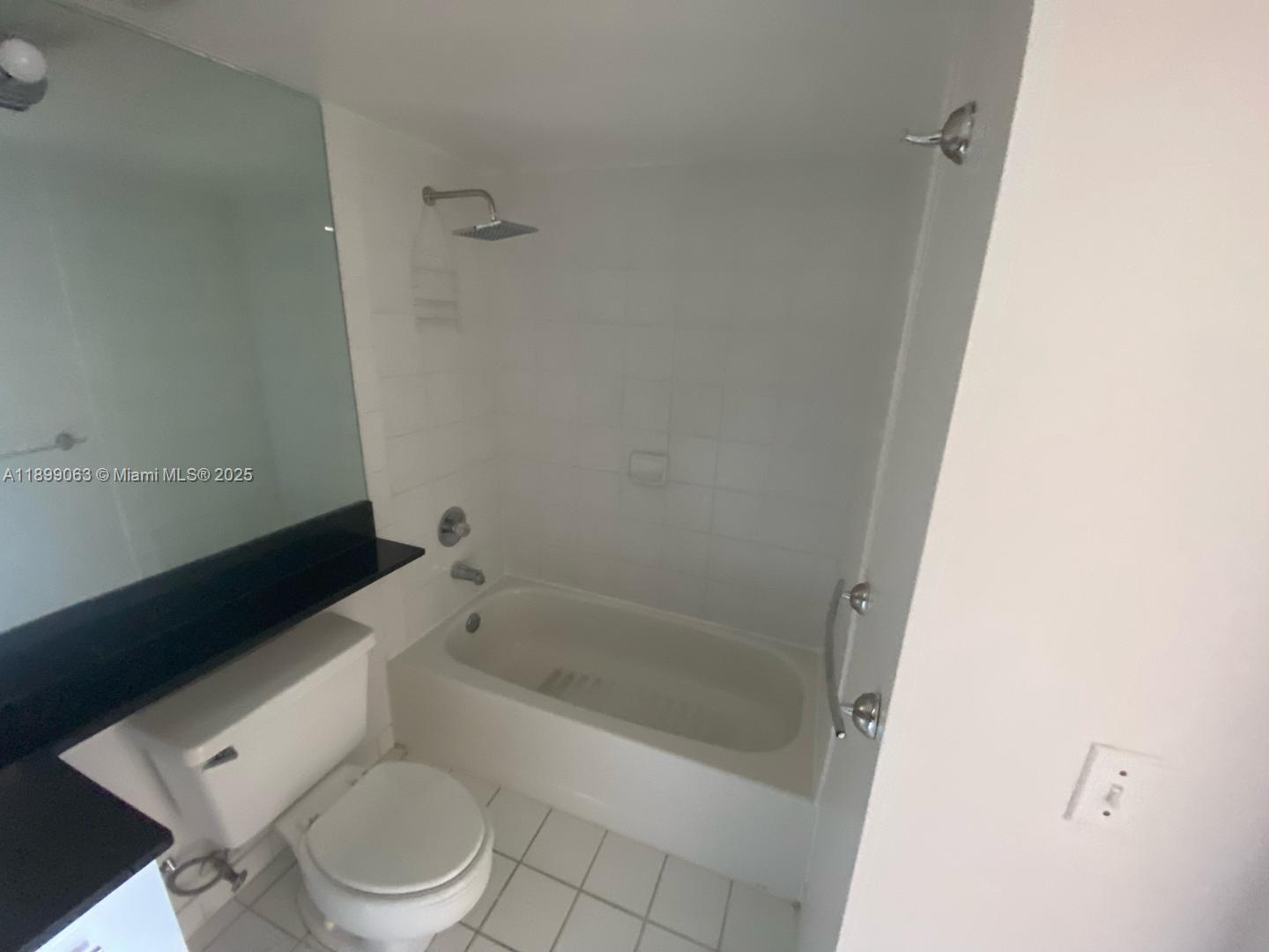 3300 Northeast 191st Street, Unit 416 Aventura, FL 33180 - Photo 18 of 26 a white toilet sitting next to a bath tub