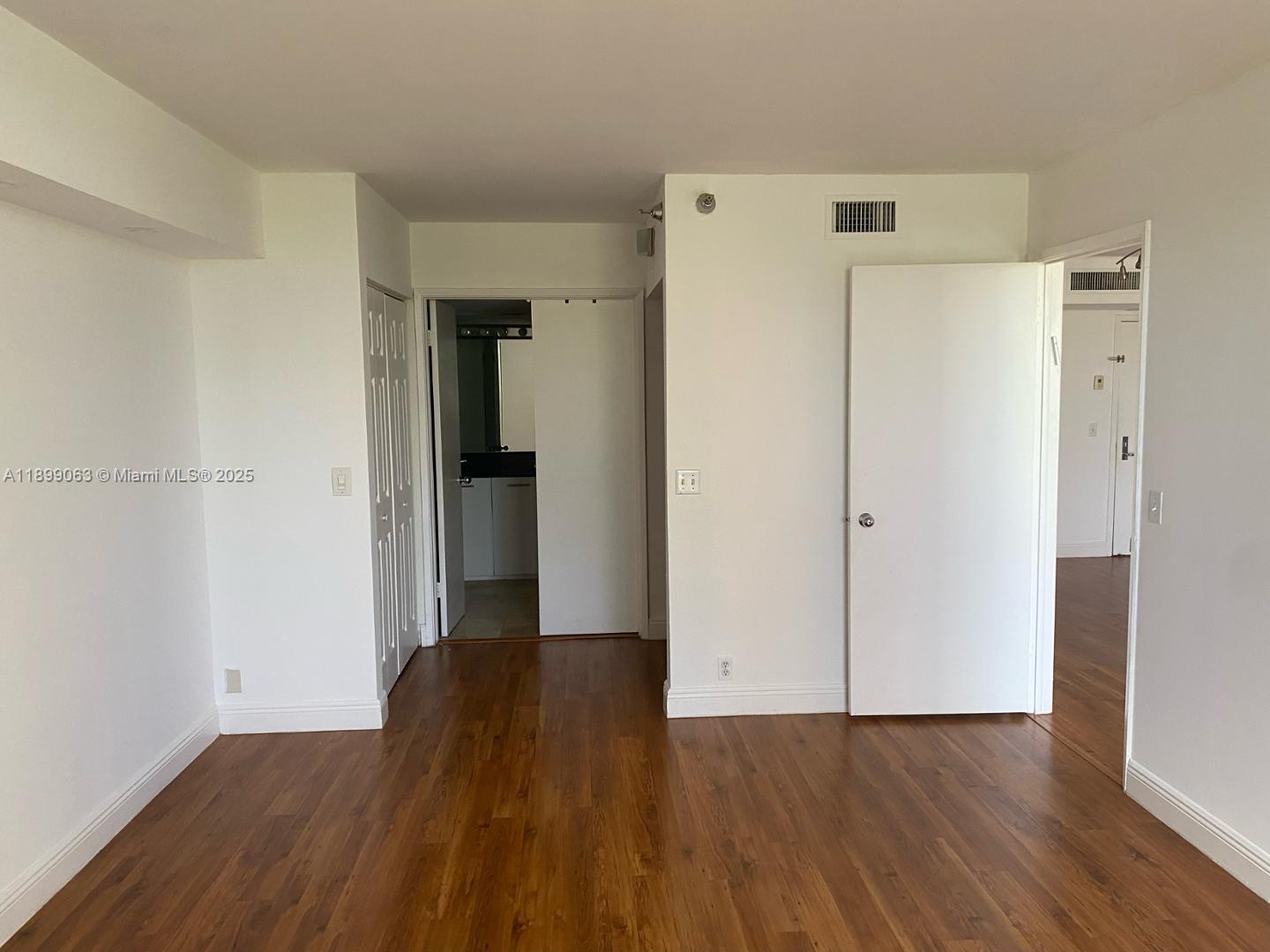 3300 Northeast 191st Street, Unit 416 Aventura, FL 33180 - Photo 7 of 26 a view of a room with wooden floor and a refrigerator