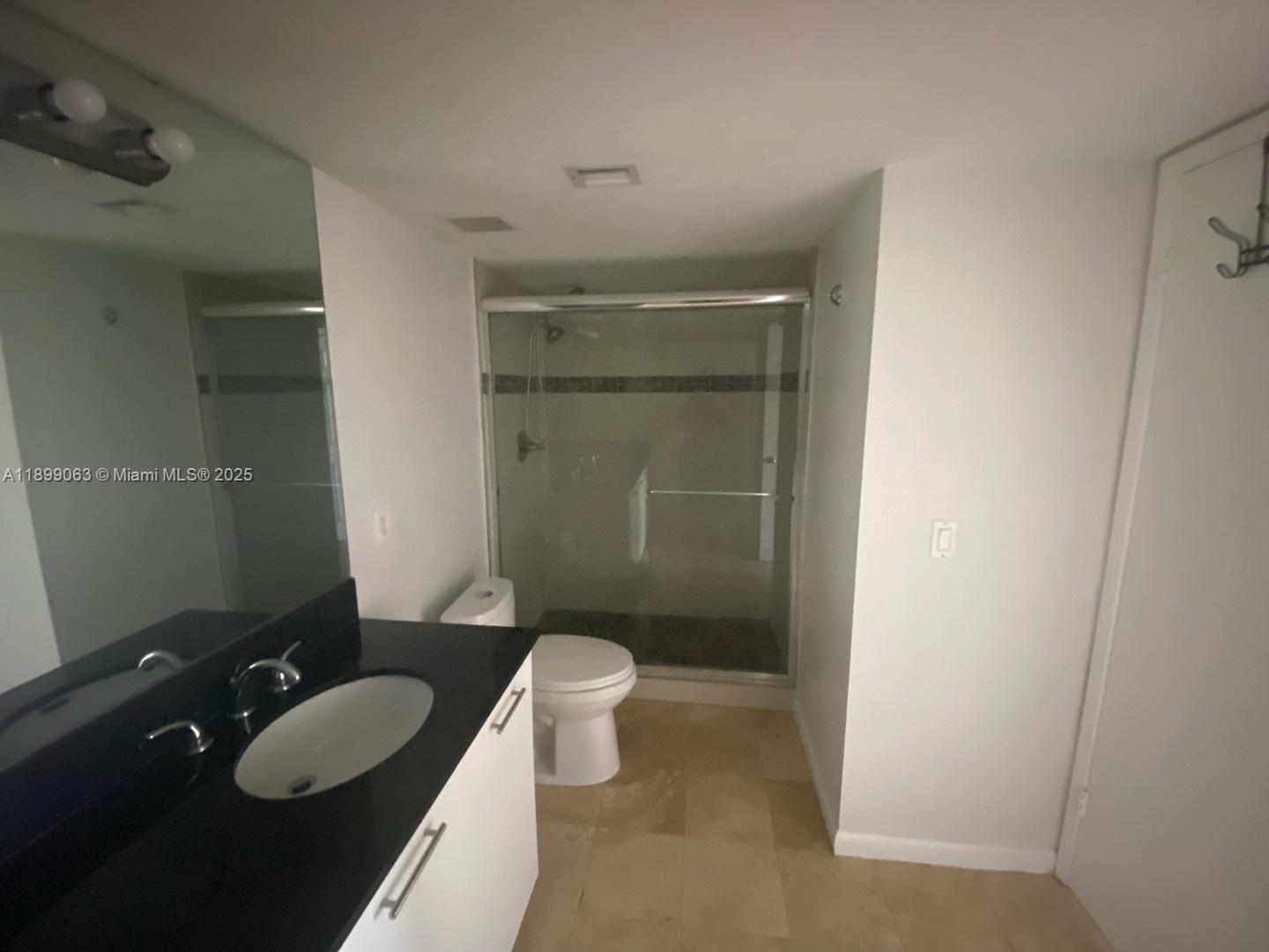3300 Northeast 191st Street, Unit 416 Aventura, FL 33180 - Photo 8 of 26 a bathroom with a granite countertop sink a toilet a and mirror