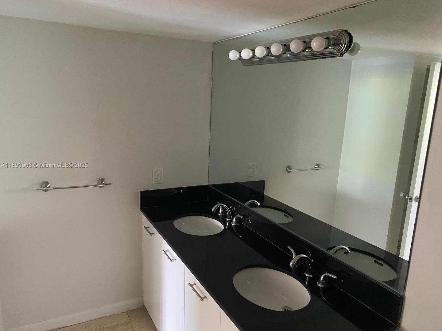 3300 Northeast 191st Street, Unit 416 Aventura, FL 33180 - Photo 9 of 26 a bathroom with a sink and mirror