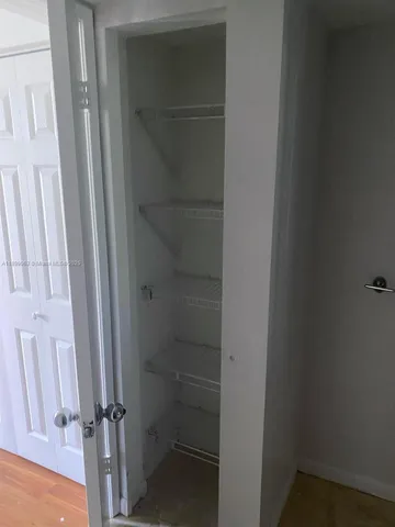 a bathroom with a glass door shower and toilet