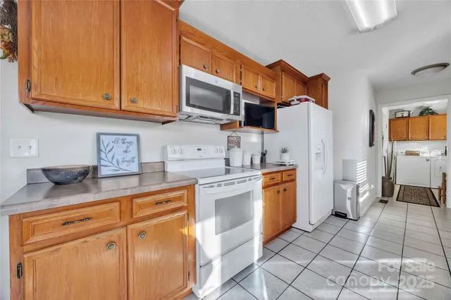 a kitchen with stainless steel appliances granite countertop a refrigerator and microwave