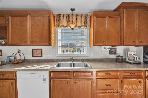 a kitchen with sink cabinets and window