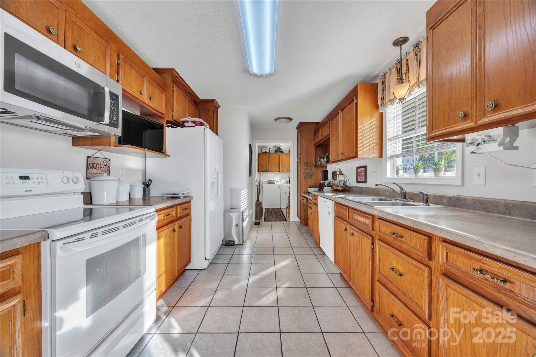 57 Riverview Road Taylorsville, NC 28681 - Photo 14 of 30 a large kitchen with stainless steel appliances granite countertop a stove a sink and a microwave
