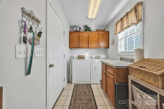 a utility room with a stove a washer and dryer