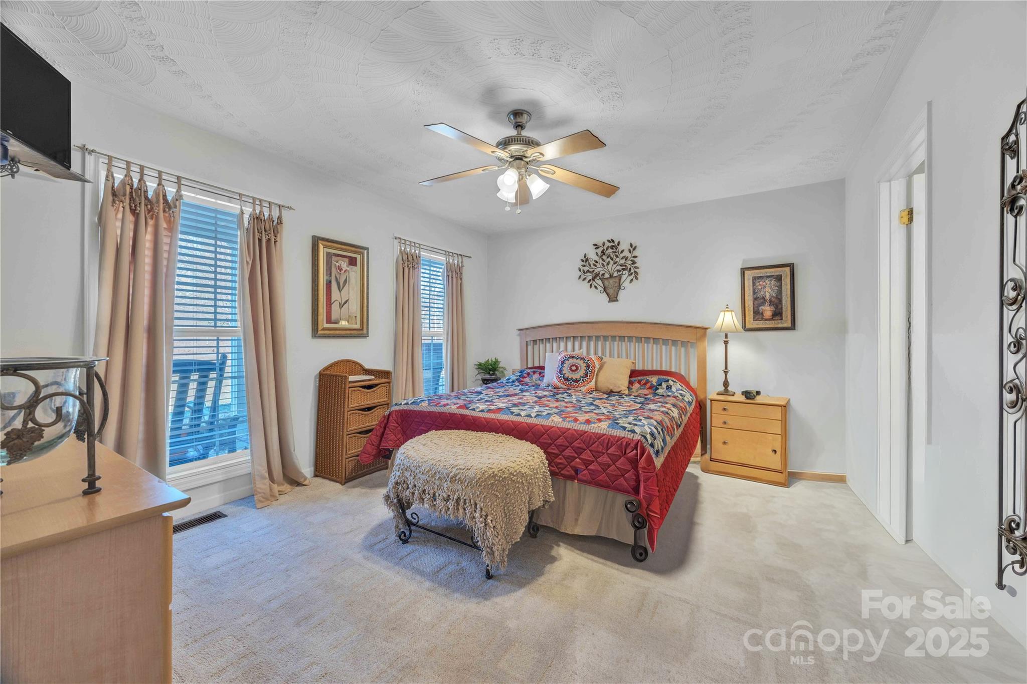 57 Riverview Road Taylorsville, NC 28681 - Photo 17 of 30 a bedroom with a bed and a chandelier