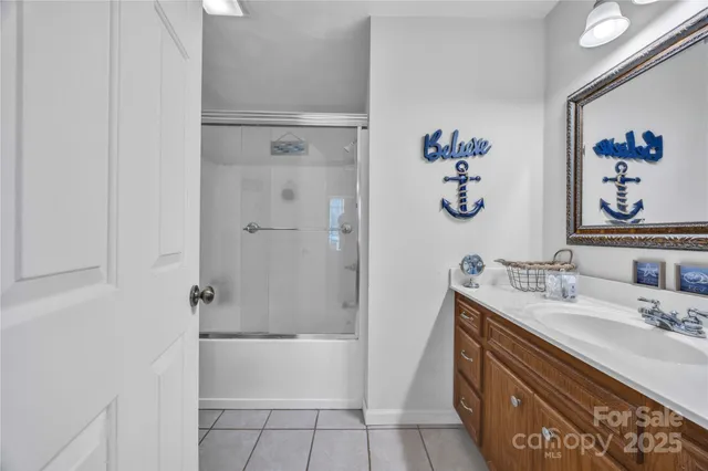 a bathroom with a sink a mirror and a shower