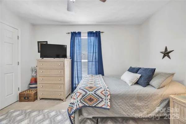 a bedroom with a bed and a television