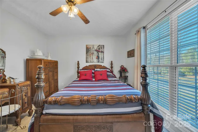 a bedroom with furniture and a chandelier