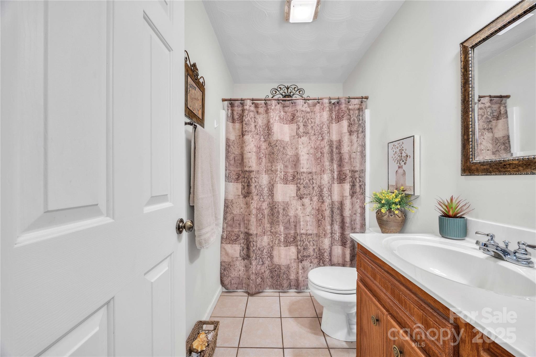 57 Riverview Road Taylorsville, NC 28681 - Photo 27 of 30 a bathroom with a granite countertop sink toilet a mirror a vanity and shower