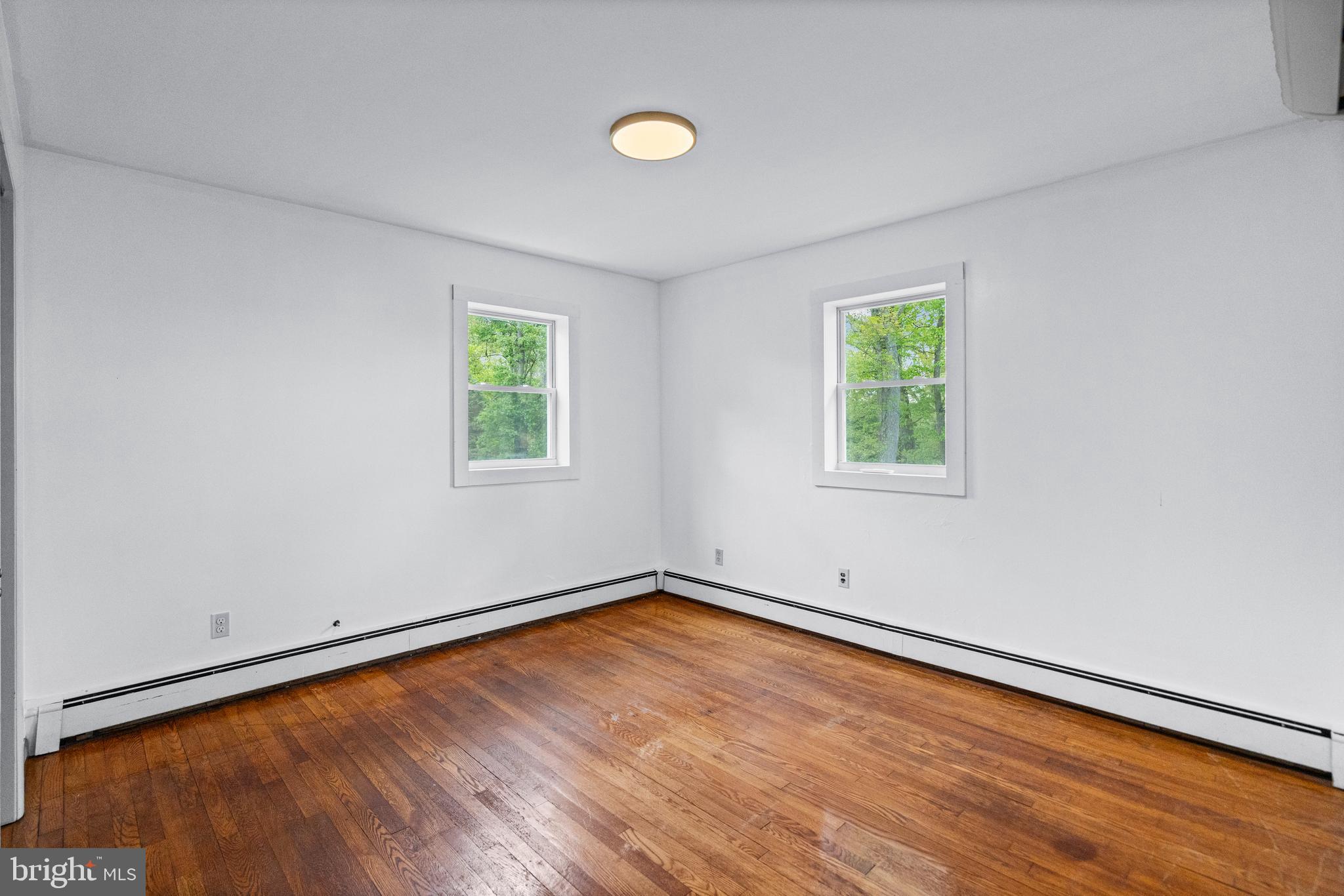 16811 Ridge Road Upperco, MD 21155 - Photo 14 of 22 an empty room with a window and wooden floor