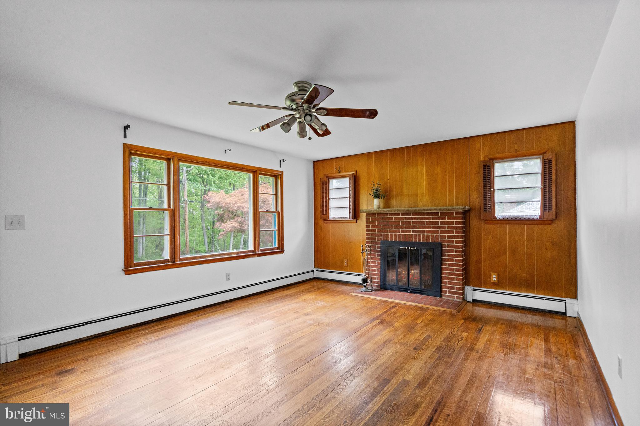 16811 Ridge Road Upperco, MD 21155 - Photo 4 of 22 wooden floor fireplace and windows in an empty room
