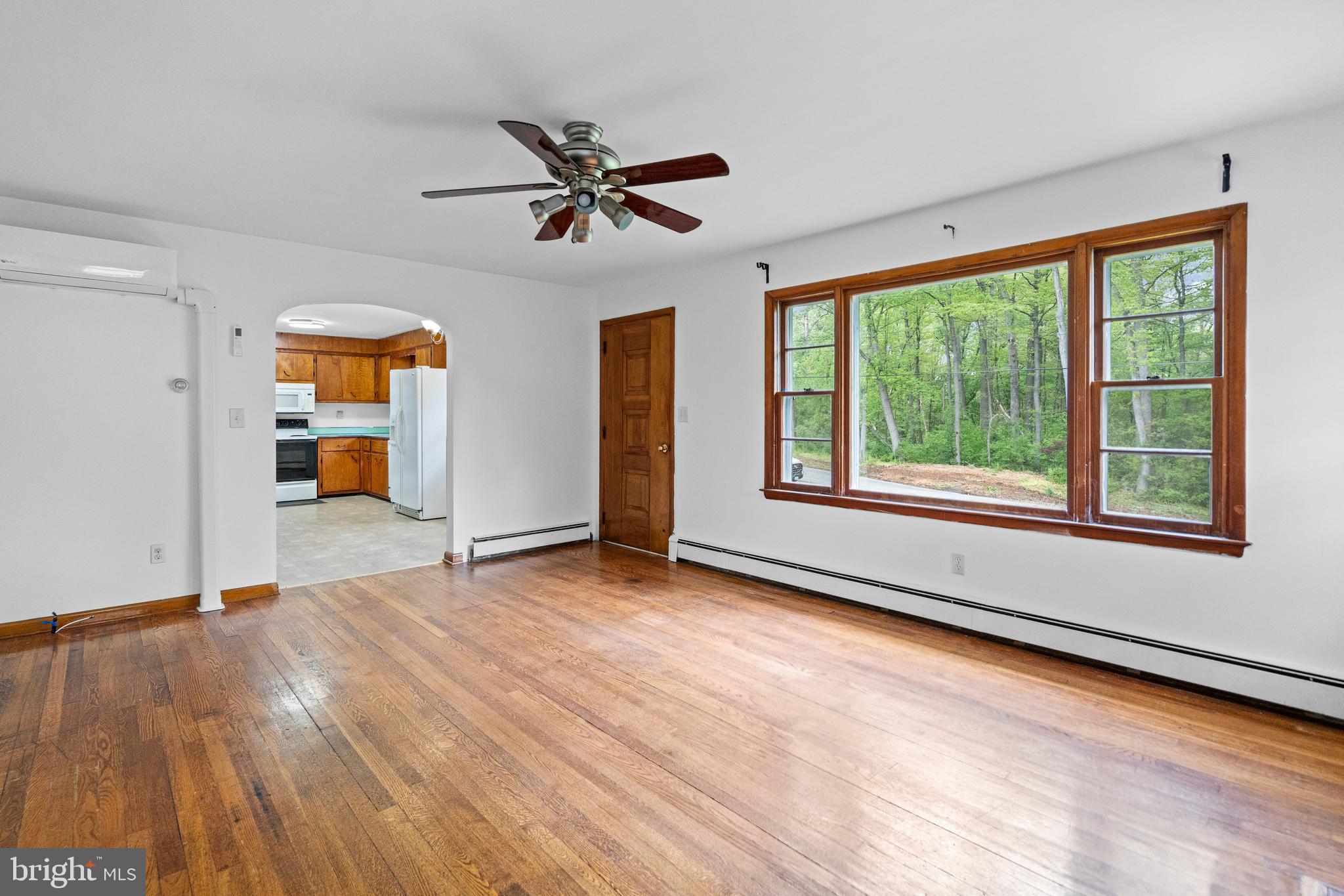 16811 Ridge Road Upperco, MD 21155 - Photo 5 of 22 a view of empty room with wooden floor and fan