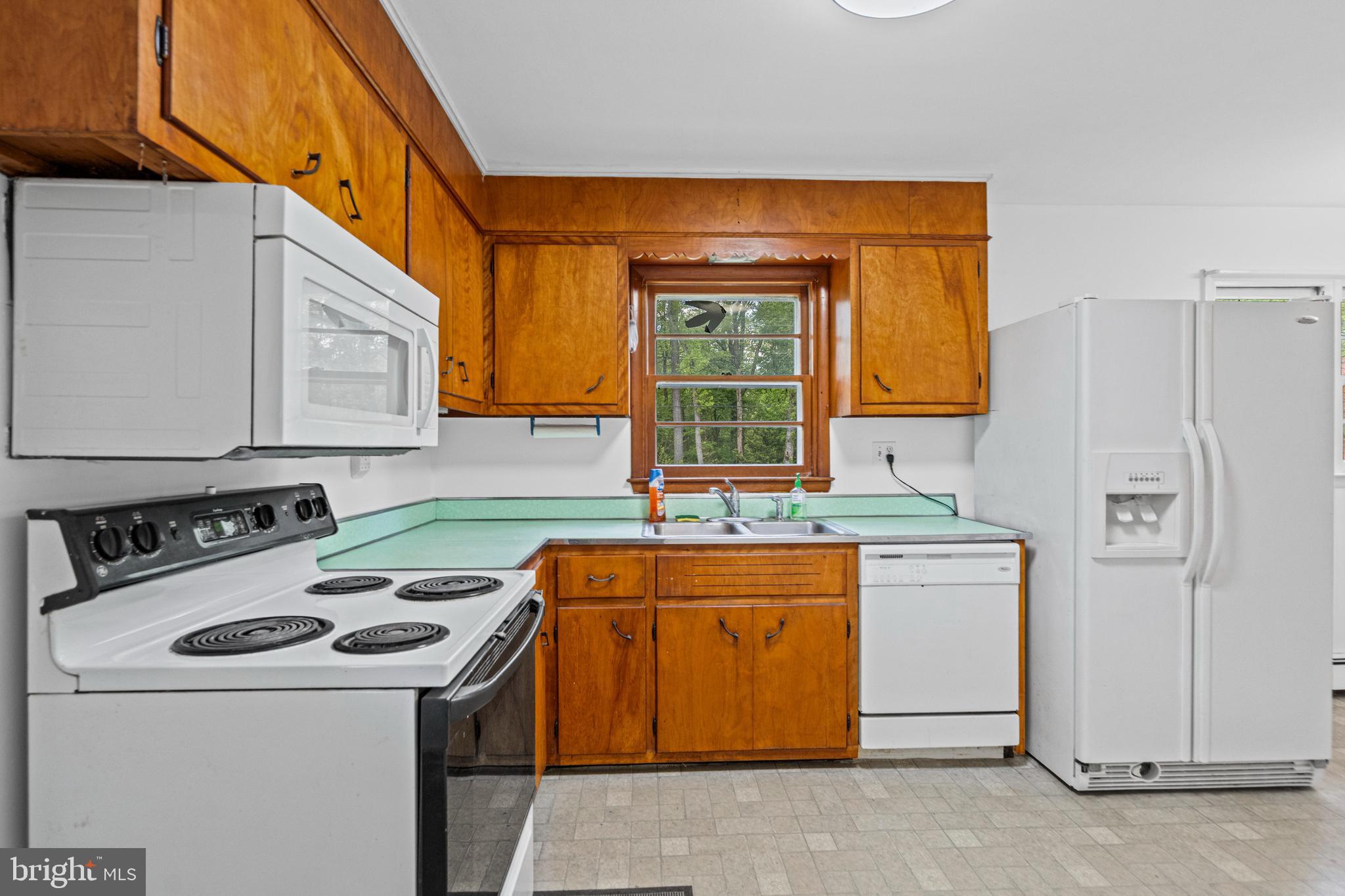 16811 Ridge Road Upperco, MD 21155 - Photo 6 of 22 a kitchen with a stove a sink and a refrigerator